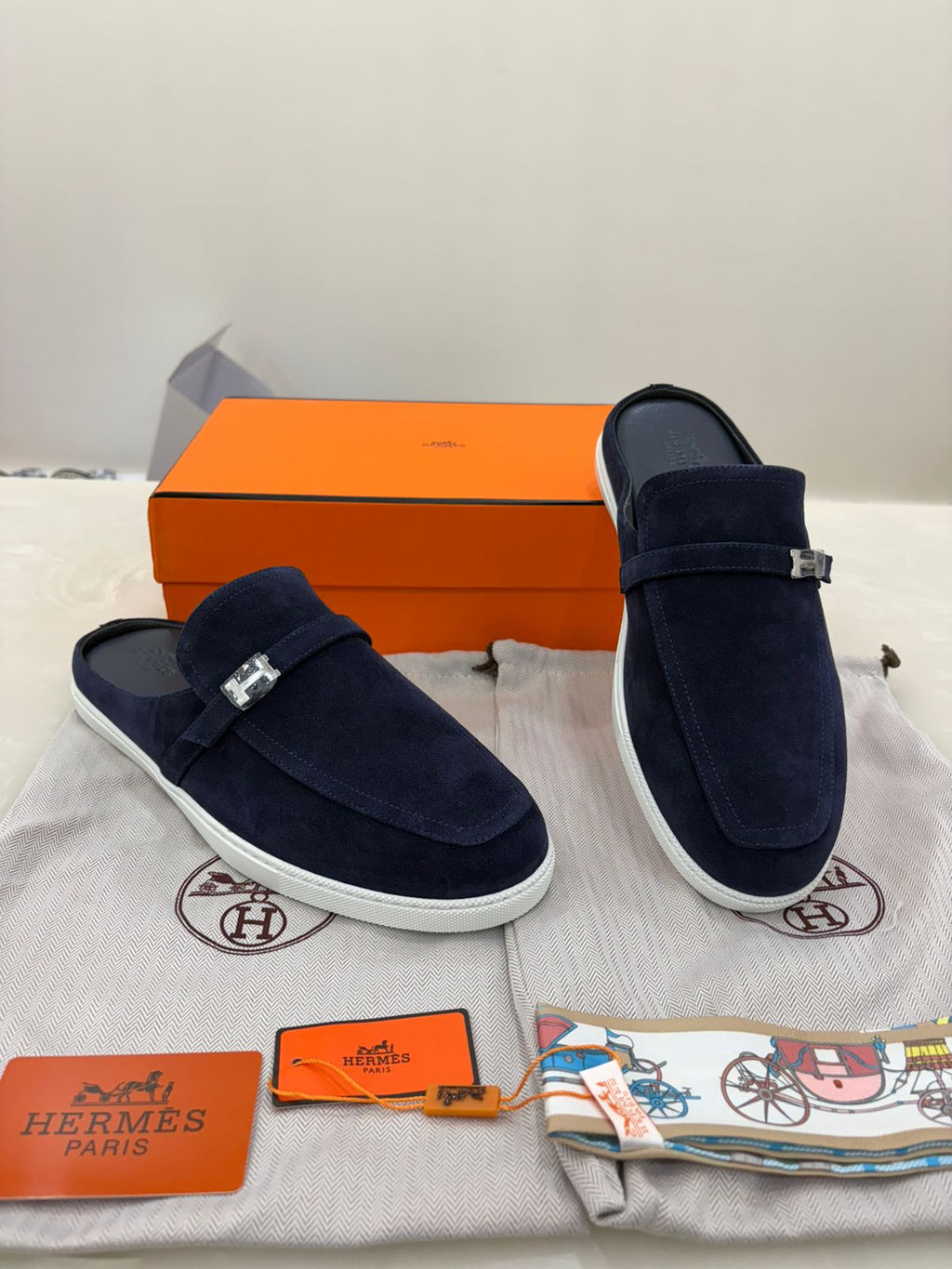 Hermès Likely mules featuring dark blue suede leather